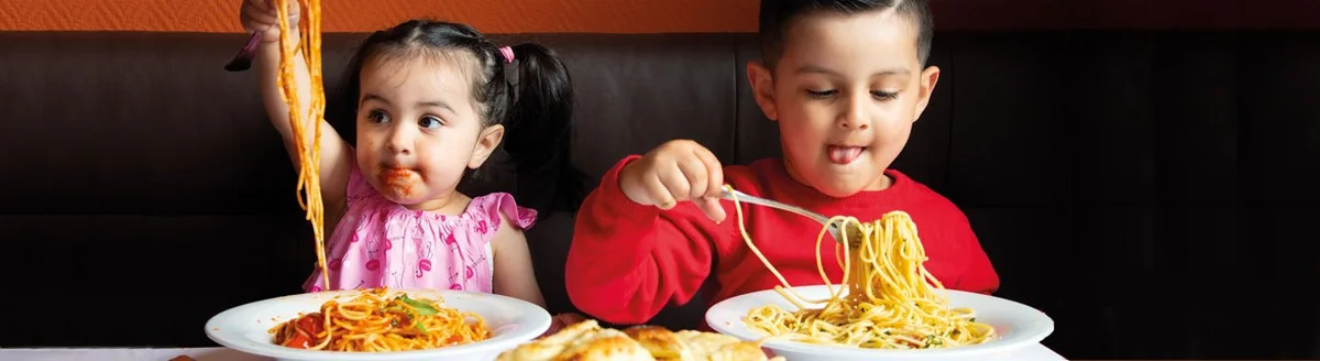 Children enjoying Italian pasta